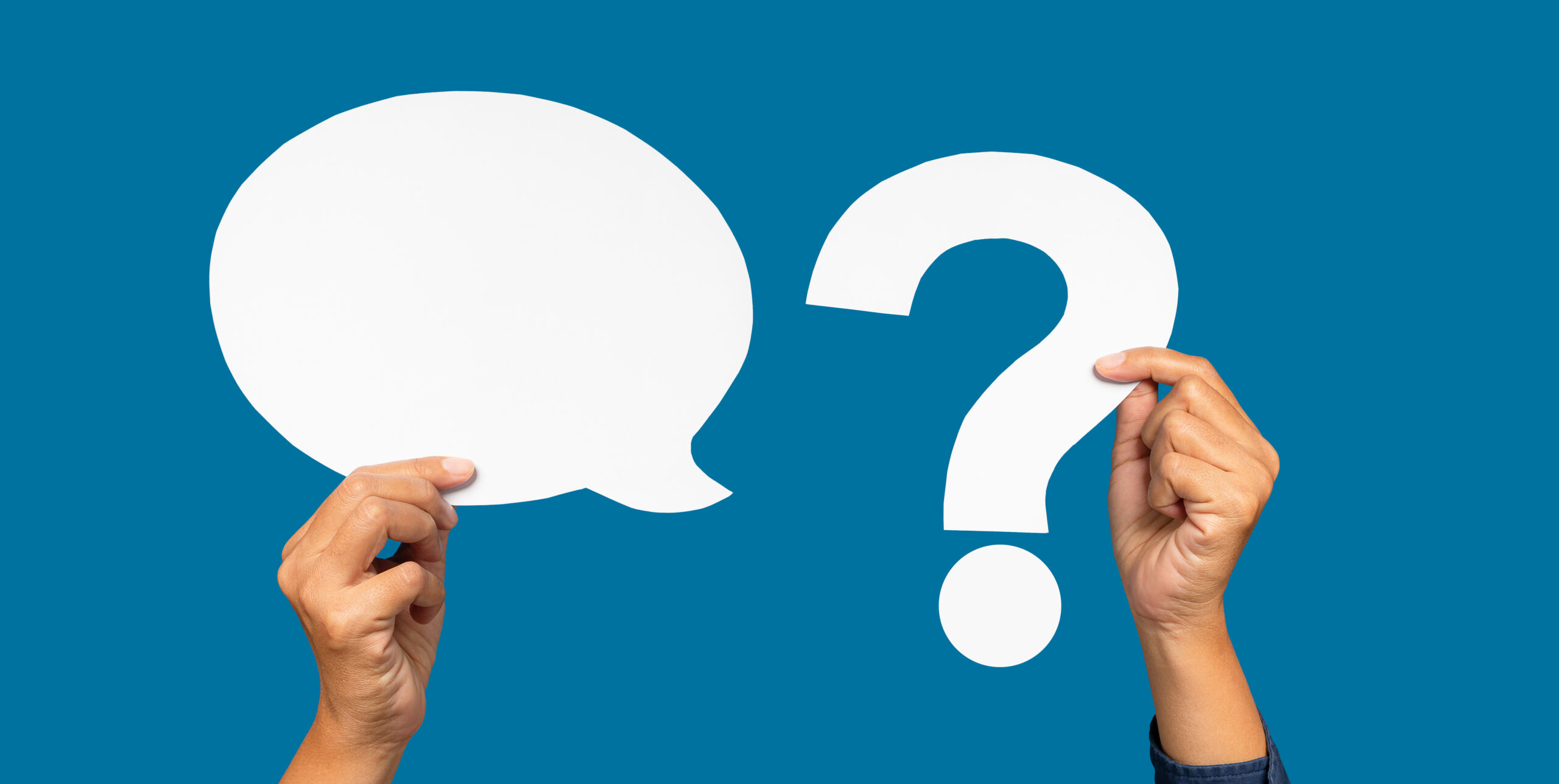A speech bubble and question mark symbol concept. Hand holding a